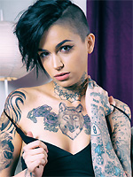 Leigh Raven exposes her inked body on the couch